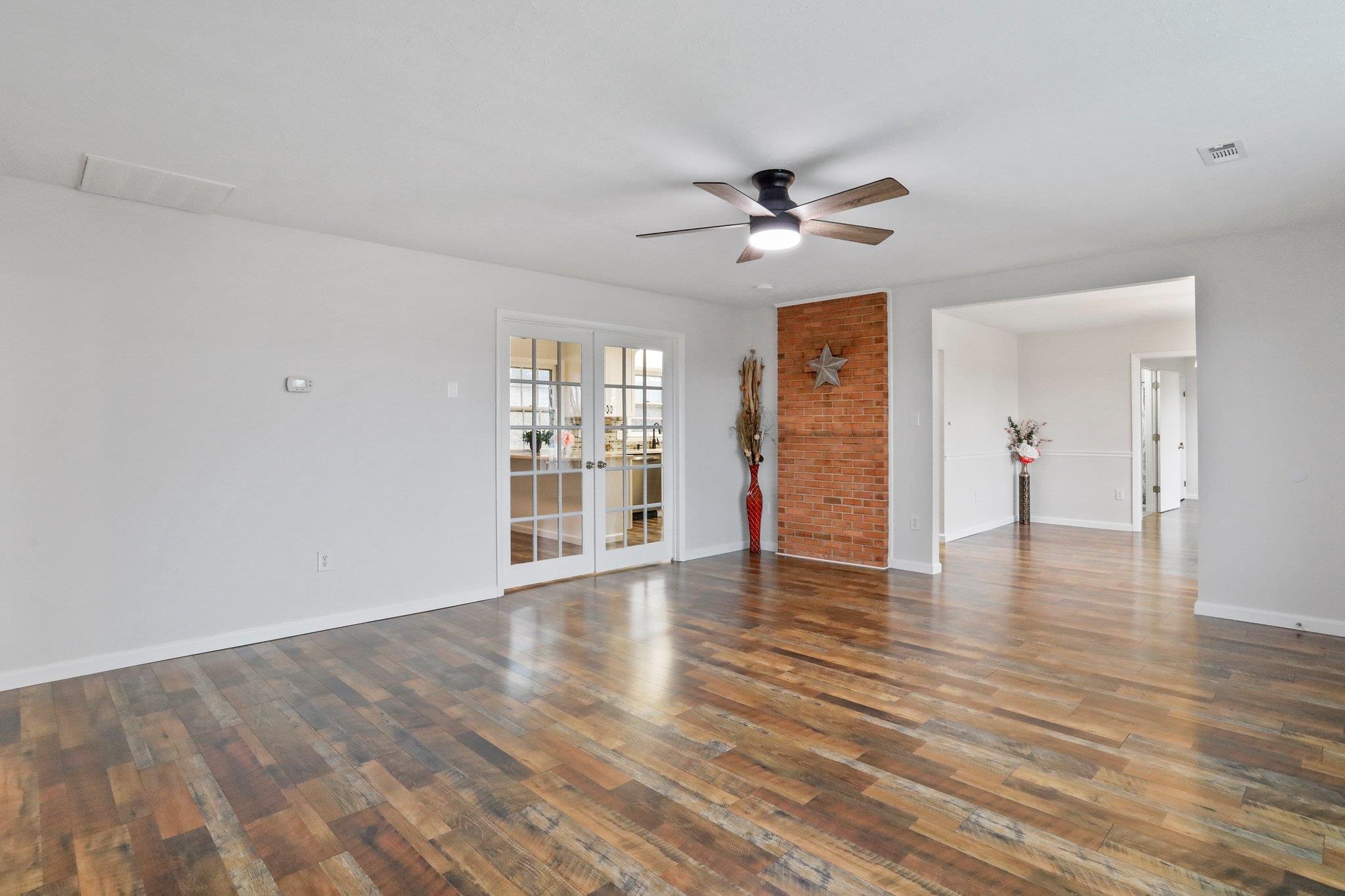 18196 New Market Road Timberville, VA 22853 - Photo 4 of 34 a view of an empty room with a window and wooden floor