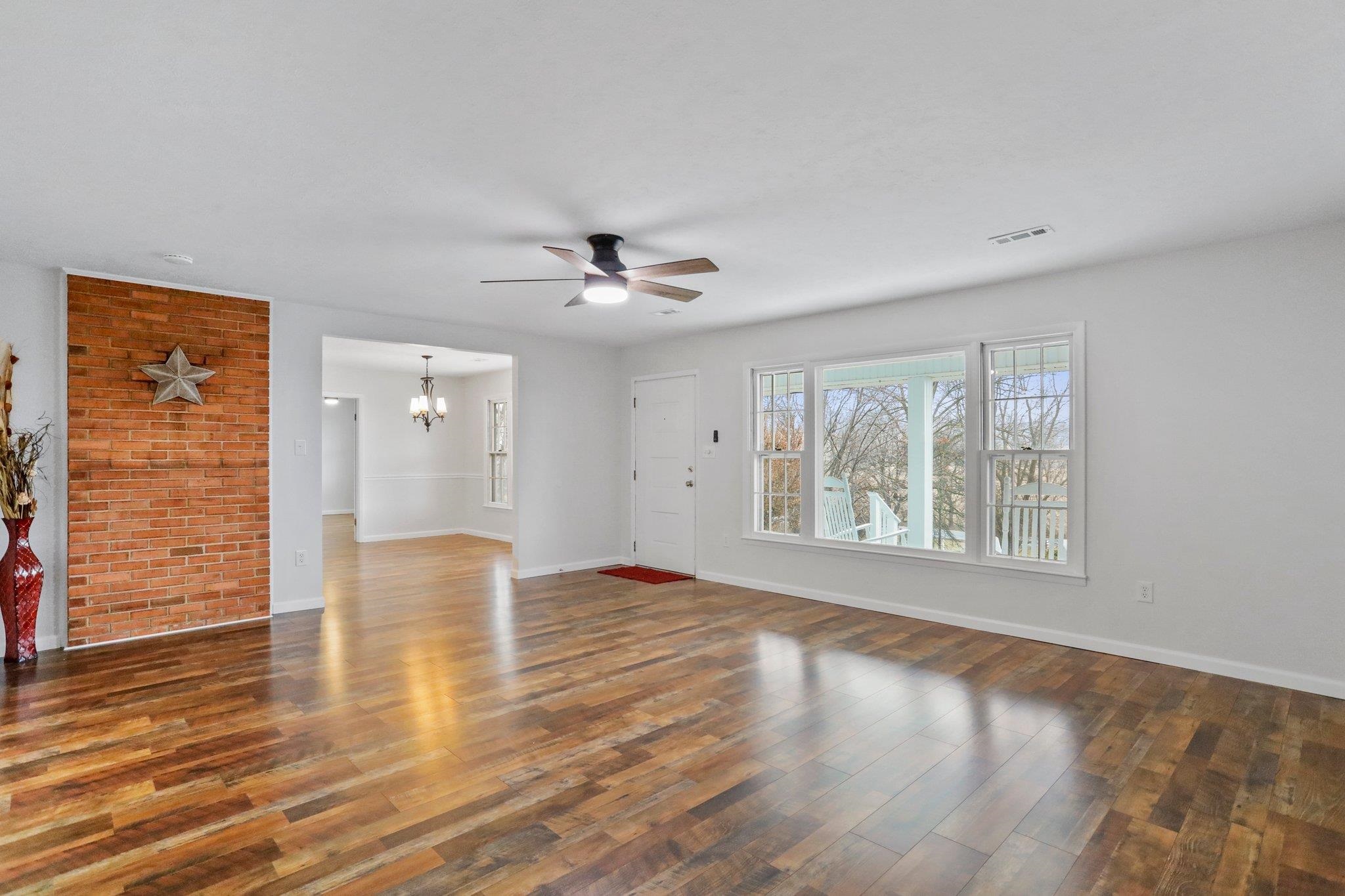 18196 New Market Road Timberville, VA 22853 - Photo 5 of 34 a view of an empty room with a window and wooden floor