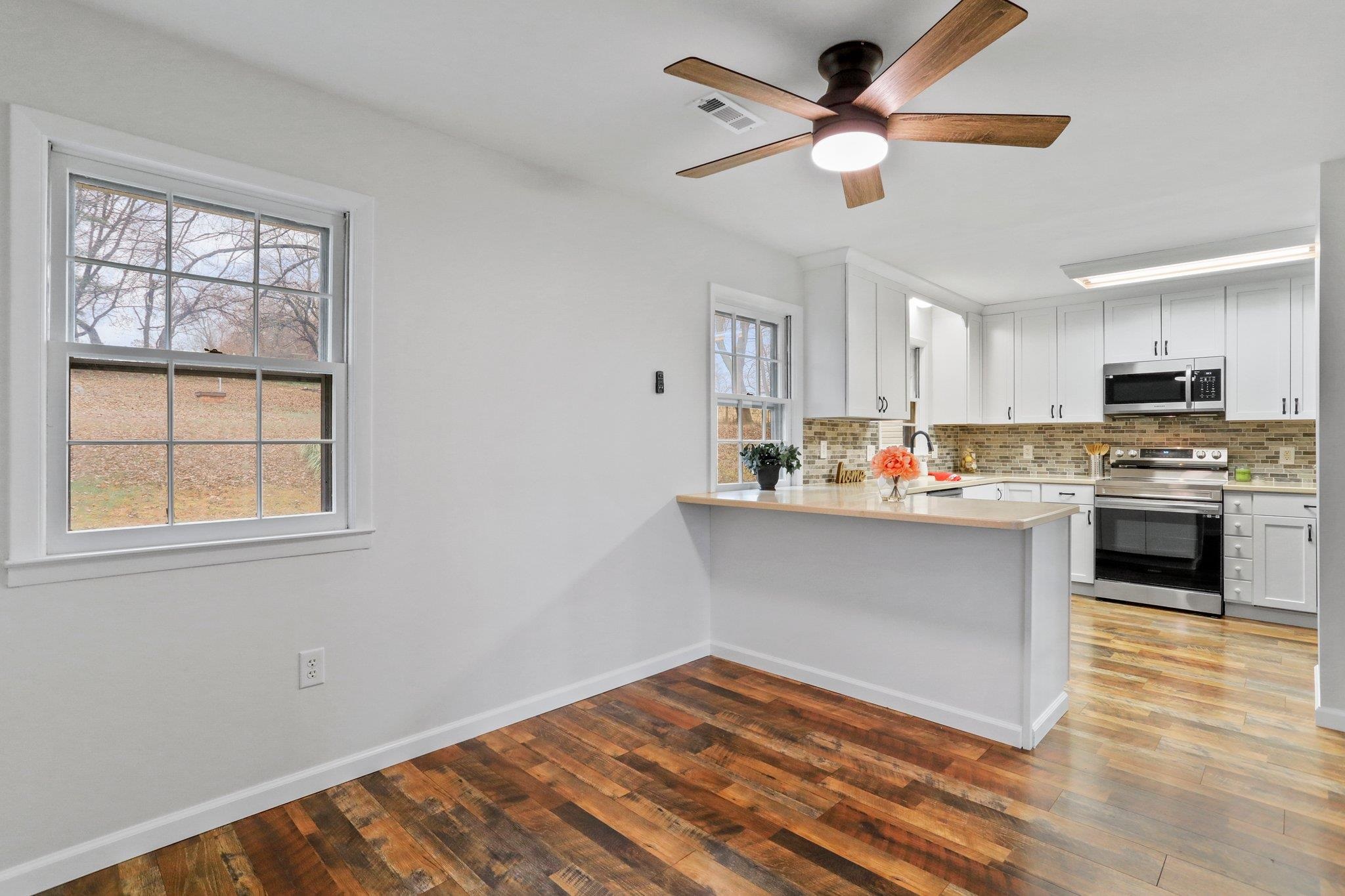 18196 New Market Road Timberville, VA 22853 - Photo 8 of 34 a kitchen with granite countertop a stove cabinets and a wooden floor