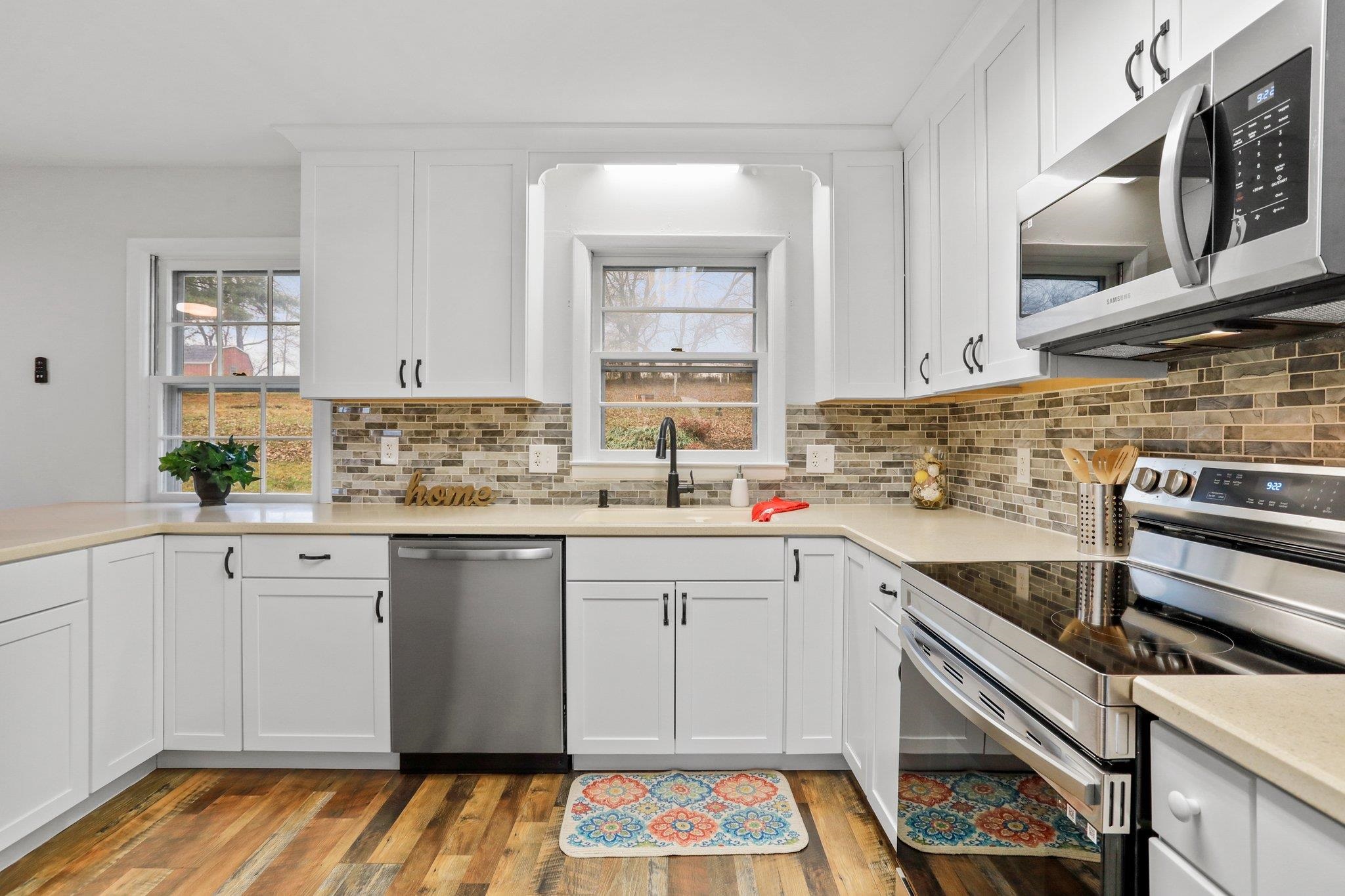 18196 New Market Road Timberville, VA 22853 - Photo 10 of 34 a kitchen with a sink stove and cabinets