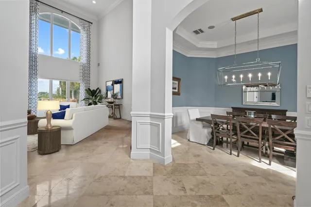 a view of a building with floor to ceiling windows and a yard