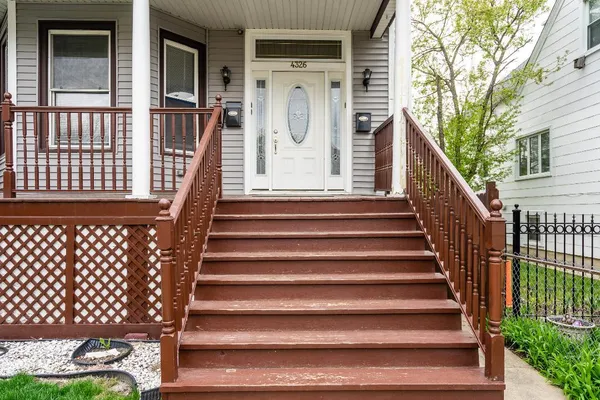 a view of entryway with wooden door and wooden floor