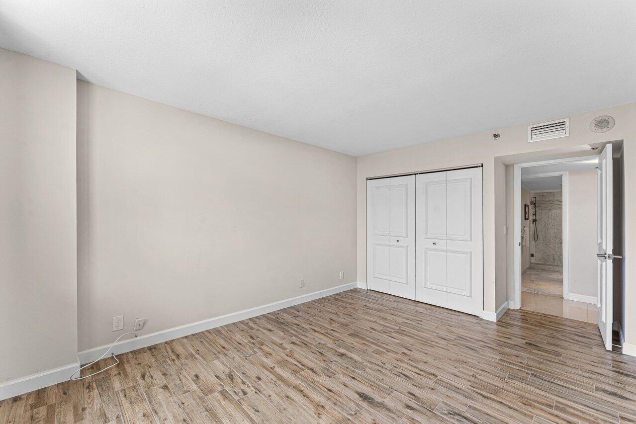 2003 North Ocean Boulevard, Unit 902 Boca Raton, FL 33431 - Photo 27 of 45 a view of an empty room and wooden floor