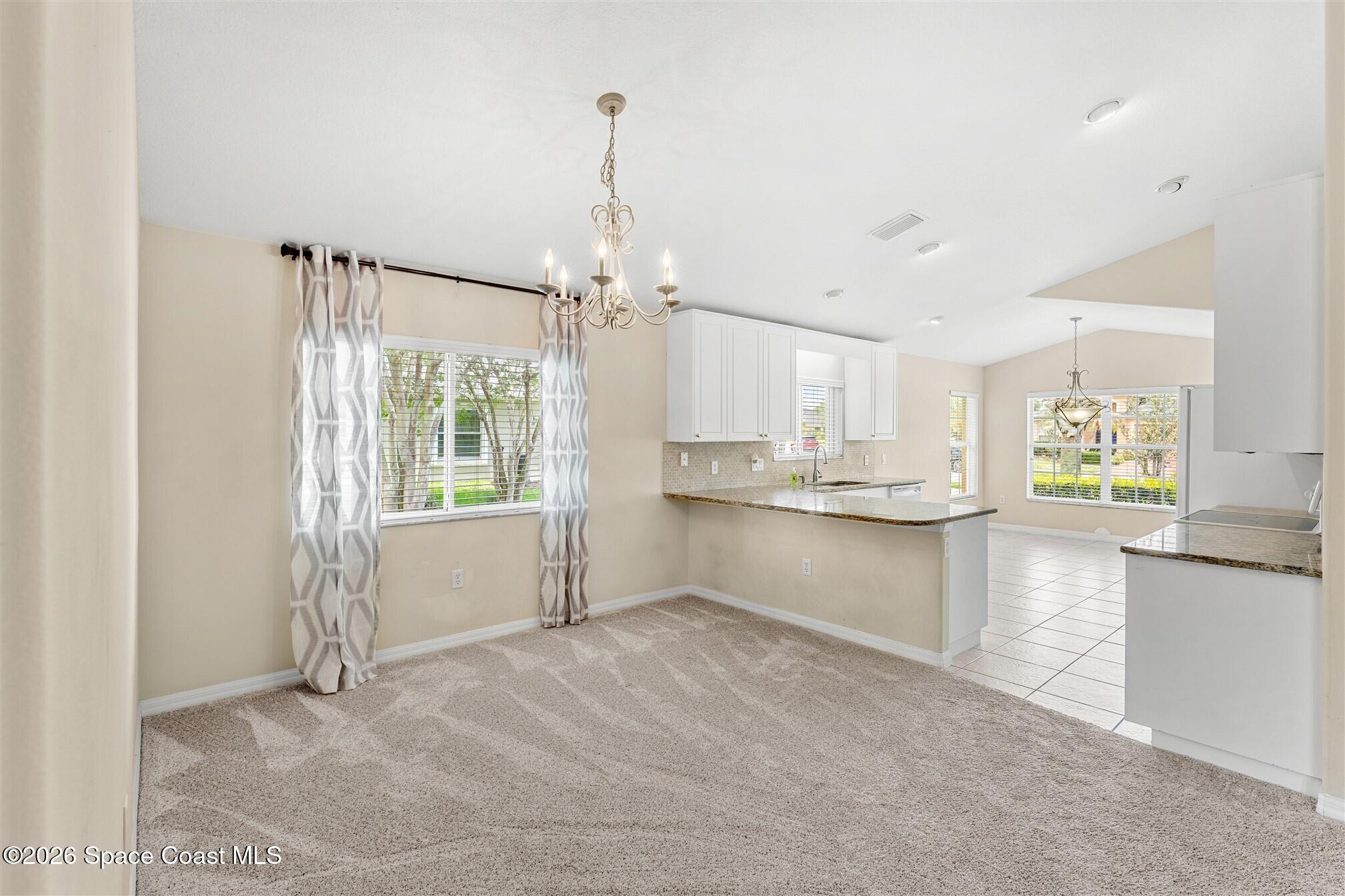 6904 Renshaw Drive Melbourne, FL 32940 - Photo 3 of 46 a view of a kitchen with refrigerator and window