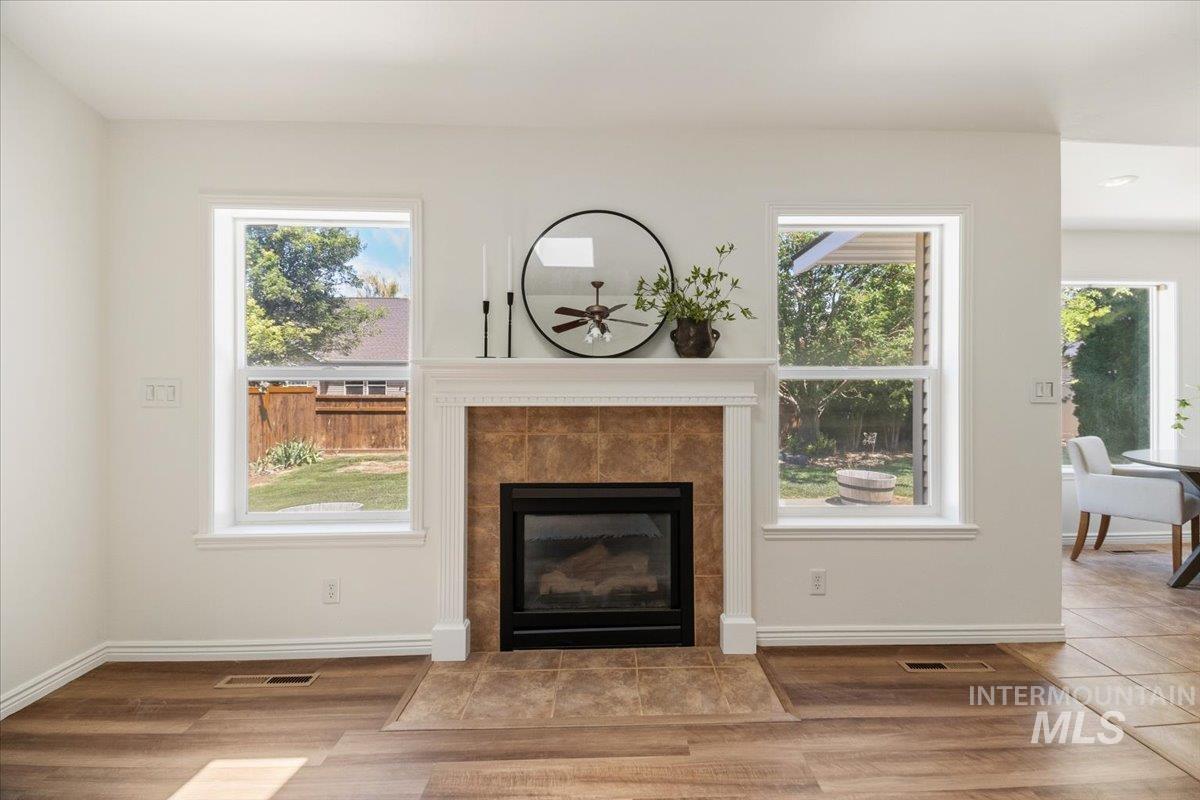 2032 Talus Loop Twin Falls, ID 83301 - Photo 11 of 43 Living area featuring a fireplace with a tiled surround, a white mantel, and a black firebox