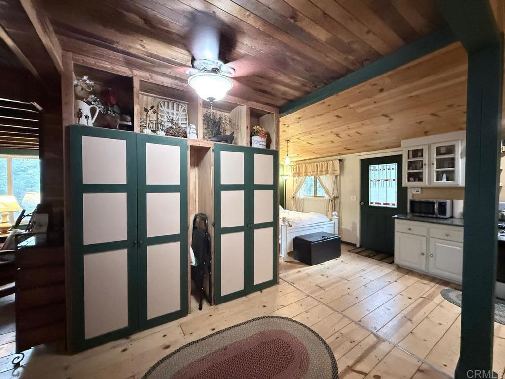 22258 Crestline Road Palomar Mountain, CA 92060 - Photo 22 of 56 a bedroom with furniture and large windows