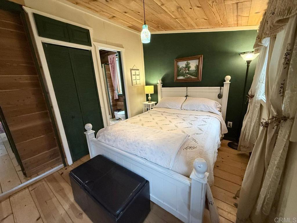 22258 Crestline Road Palomar Mountain, CA 92060 - Photo 25 of 56 a bedroom with a bed and a mirror
