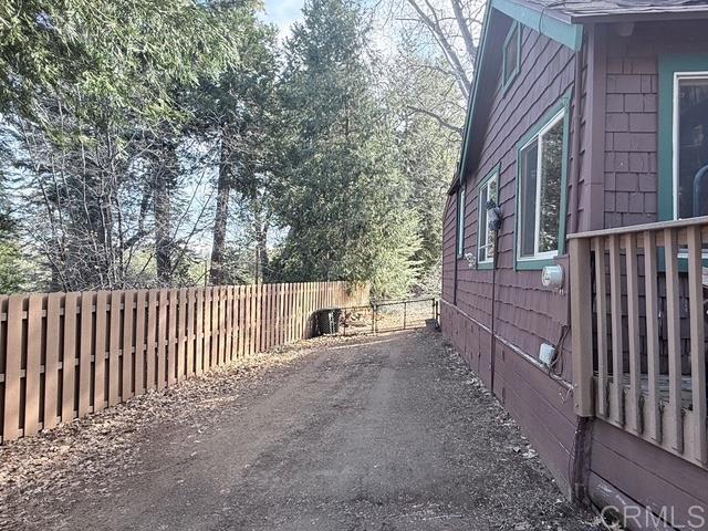 22258 Crestline Road Palomar Mountain, CA 92060 - Photo 48 of 56 a view of a house with a small yard and wooden fence