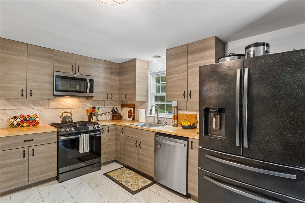 355 Wares Road Ashby, MA 01431 - Photo 12 of 38 a kitchen with stainless steel appliances a sink stove and refrigerator