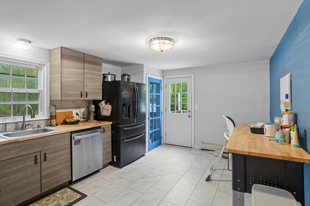 355 Wares Road Ashby, MA 01431 - Photo 13 of 38 a kitchen with stainless steel appliances a refrigerator and a sink