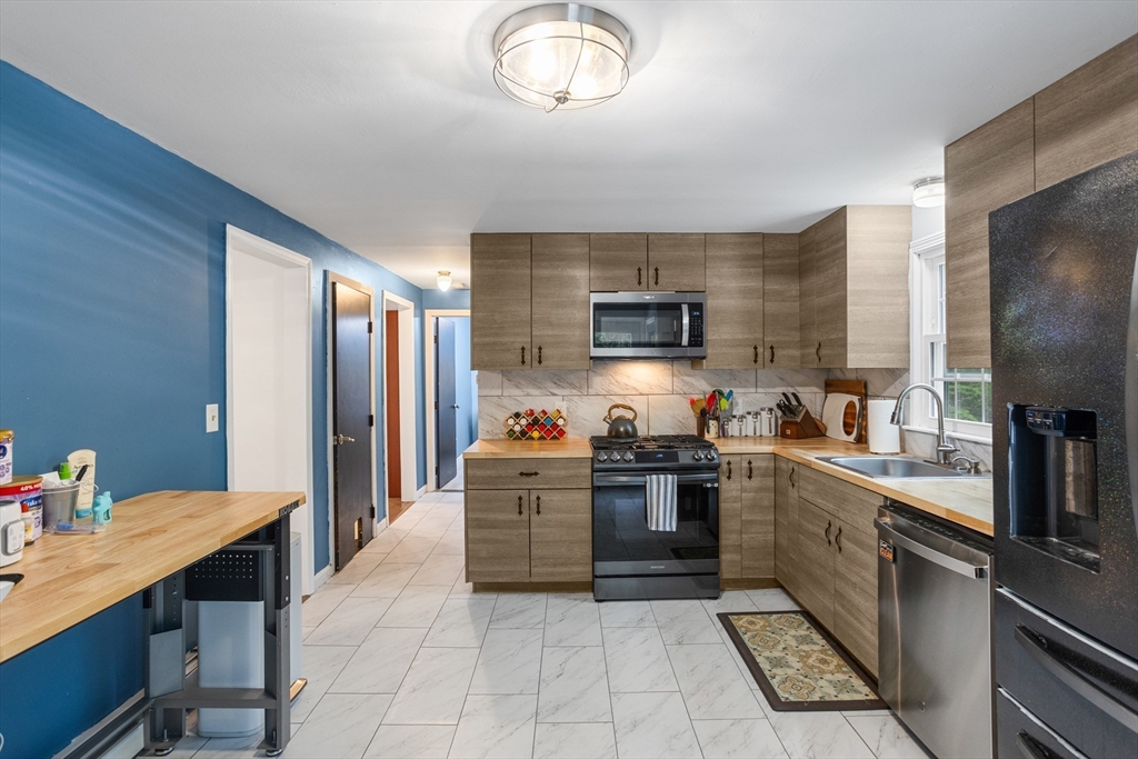 355 Wares Road Ashby, MA 01431 - Photo 15 of 38 a kitchen with stainless steel appliances kitchen island granite countertop a sink dishwasher stove top oven and cabinets