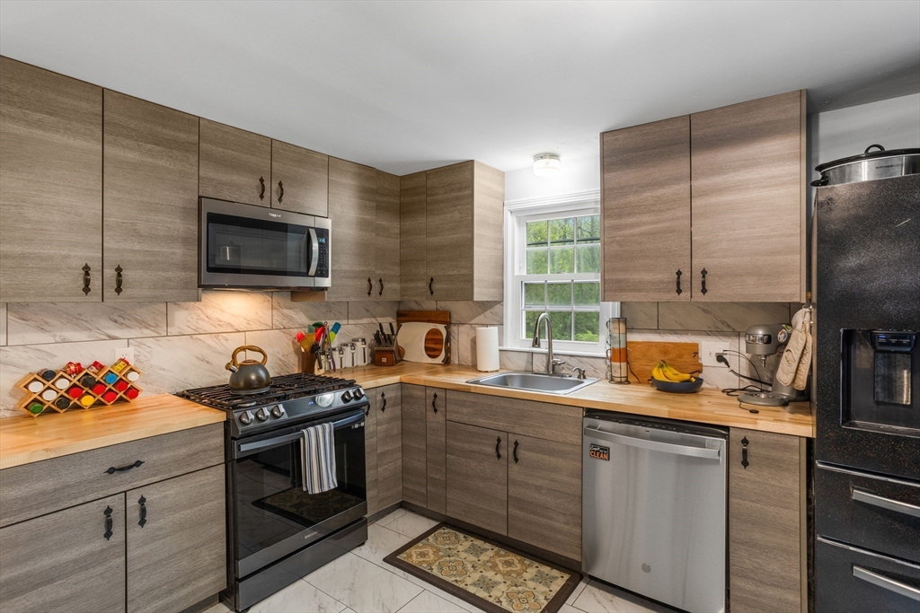 355 Wares Road Ashby, MA 01431 - Photo 16 of 38 a kitchen with stainless steel appliances a sink stove and microwave