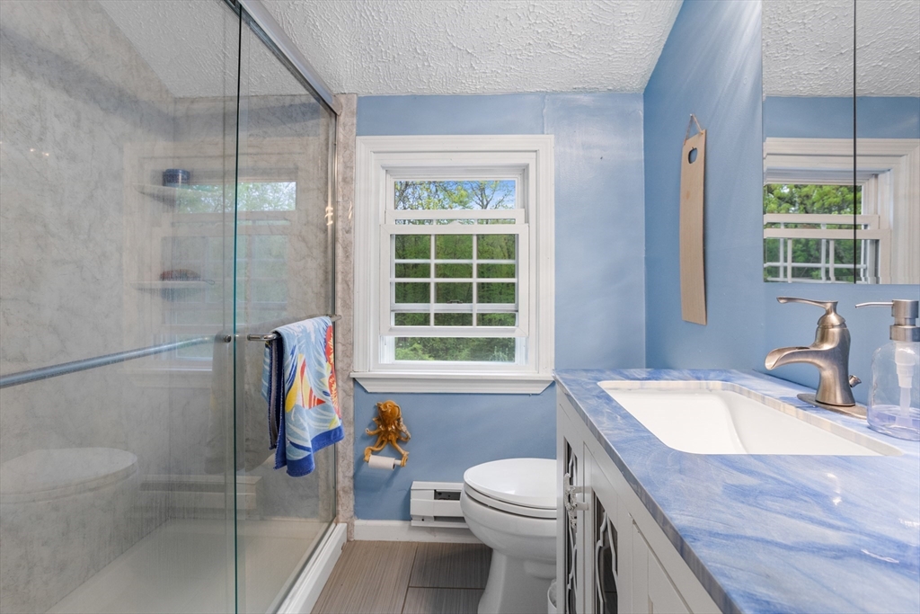 355 Wares Road Ashby, MA 01431 - Photo 23 of 38 a bathroom with a granite countertop sink a toilet and a shower