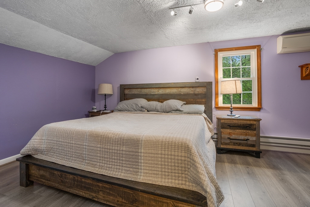 355 Wares Road Ashby, MA 01431 - Photo 25 of 38 a bedroom with a bed and a window