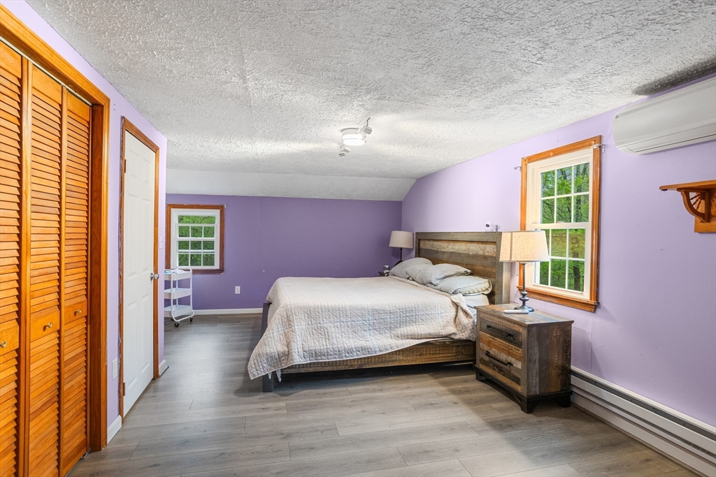 355 Wares Road Ashby, MA 01431 - Photo 27 of 38 a bedroom with a bed and wooden floor
