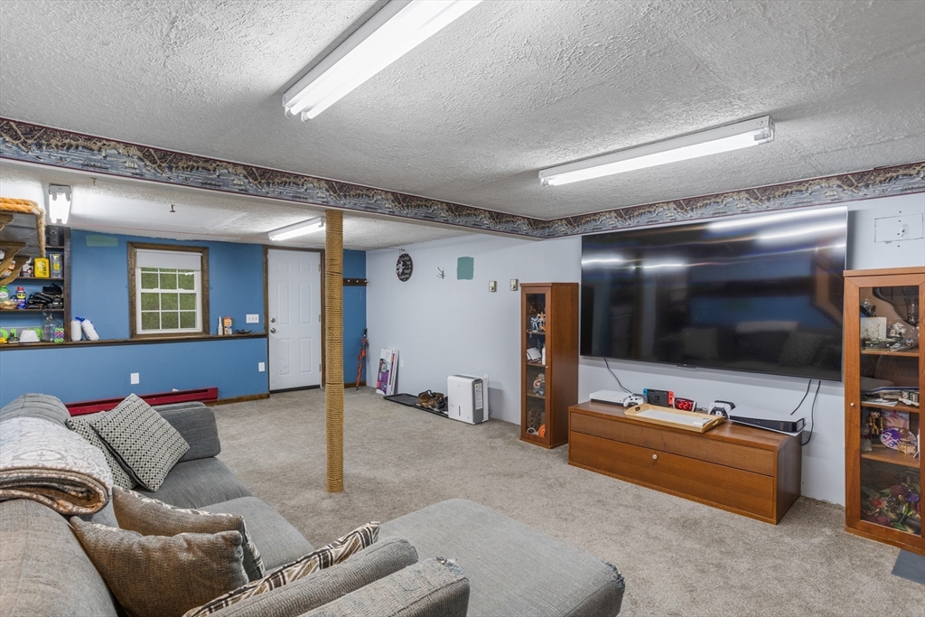 355 Wares Road Ashby, MA 01431 - Photo 28 of 38 a living room with furniture and a flat screen tv