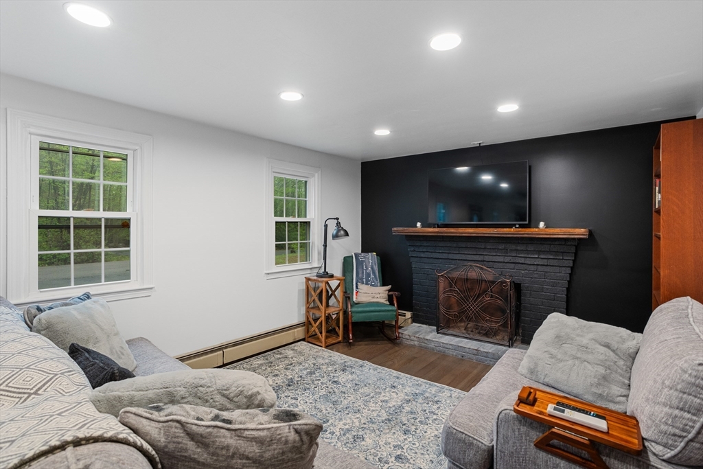 355 Wares Road Ashby, MA 01431 - Photo 7 of 38 a living room with furniture and a fireplace