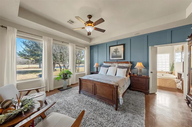 a bed room with a bed and a large window