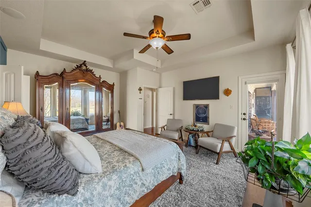 a spacious bedroom with a bed and a chandelier
