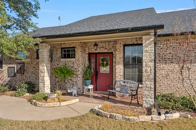 a view of a brick house with potted plants