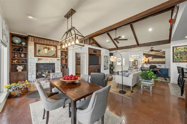 a dining room with furniture a chandelier and wooden floor