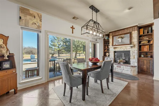 a dining room with furniture a chandelier and wooden floor