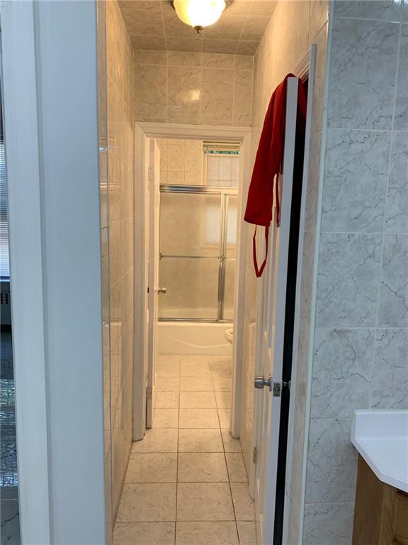 902 East 12th Street Brooklyn, NY 11230 - Photo 6 of 10 a view of walk in closet with empty racks