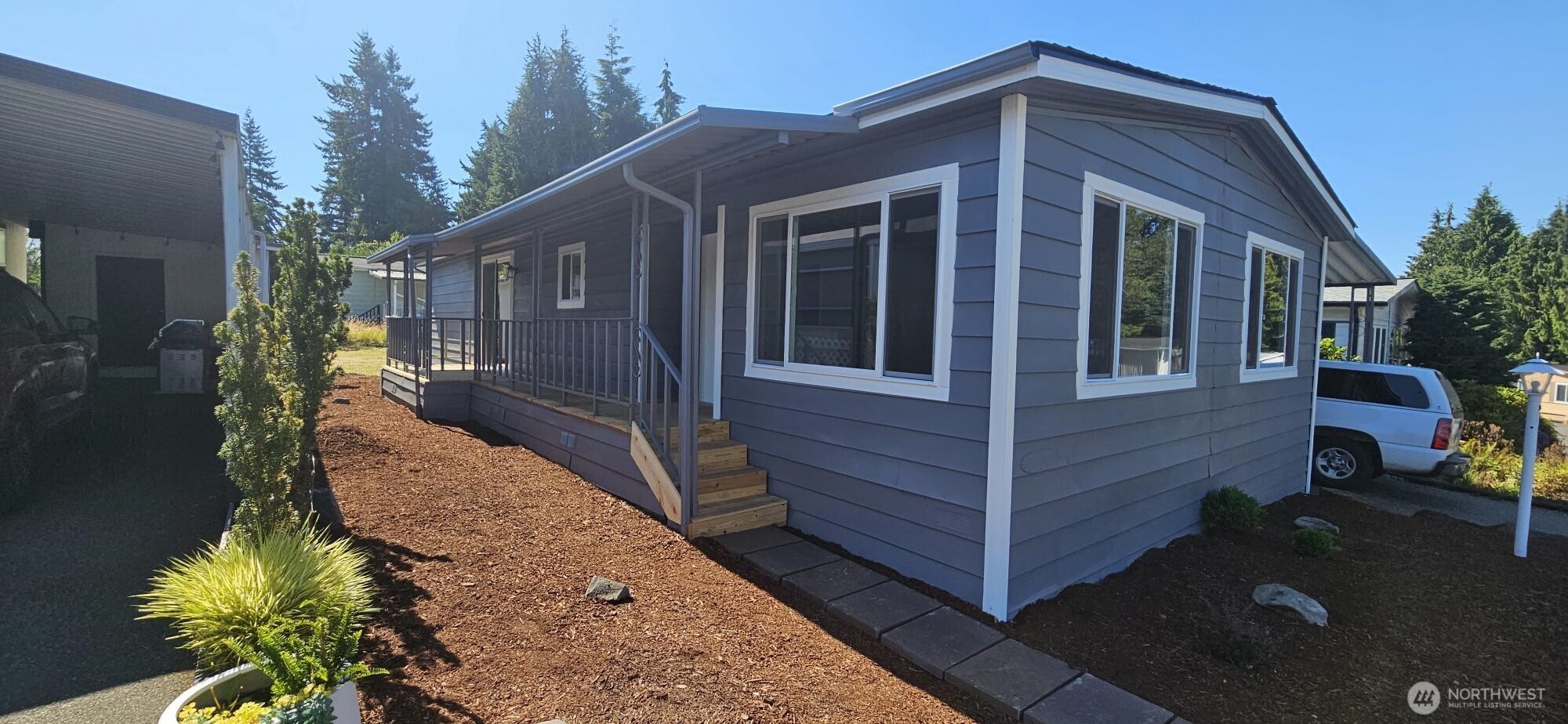 a view of a house with brick walls and a yard