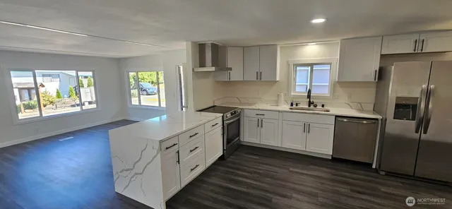 a kitchen with white cabinets and white appliances