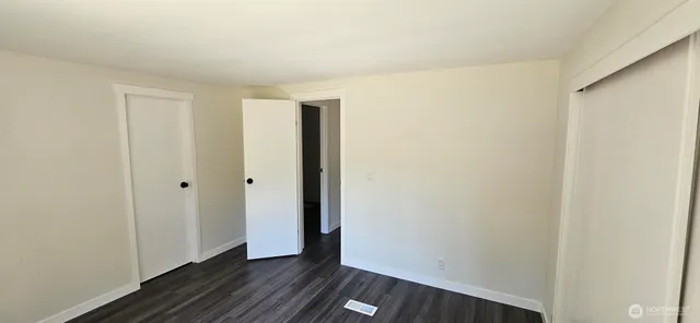 a view of a room with wooden floor