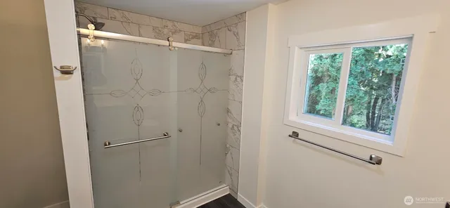 a bathroom with a glass shower door