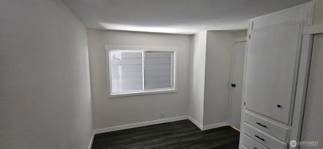 a bathroom with a granite countertop toilet a sink and shower