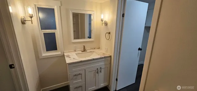 a bathroom with a sink and a mirror