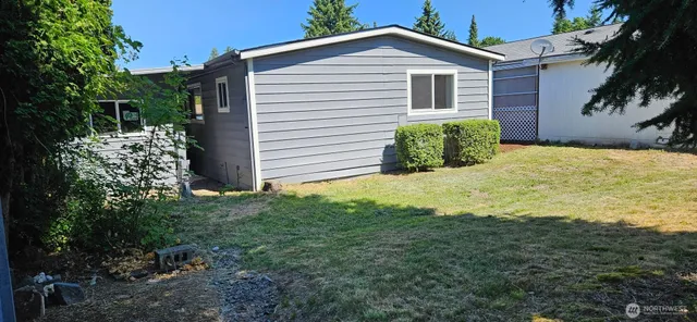 a view of an house with backyard space and garden