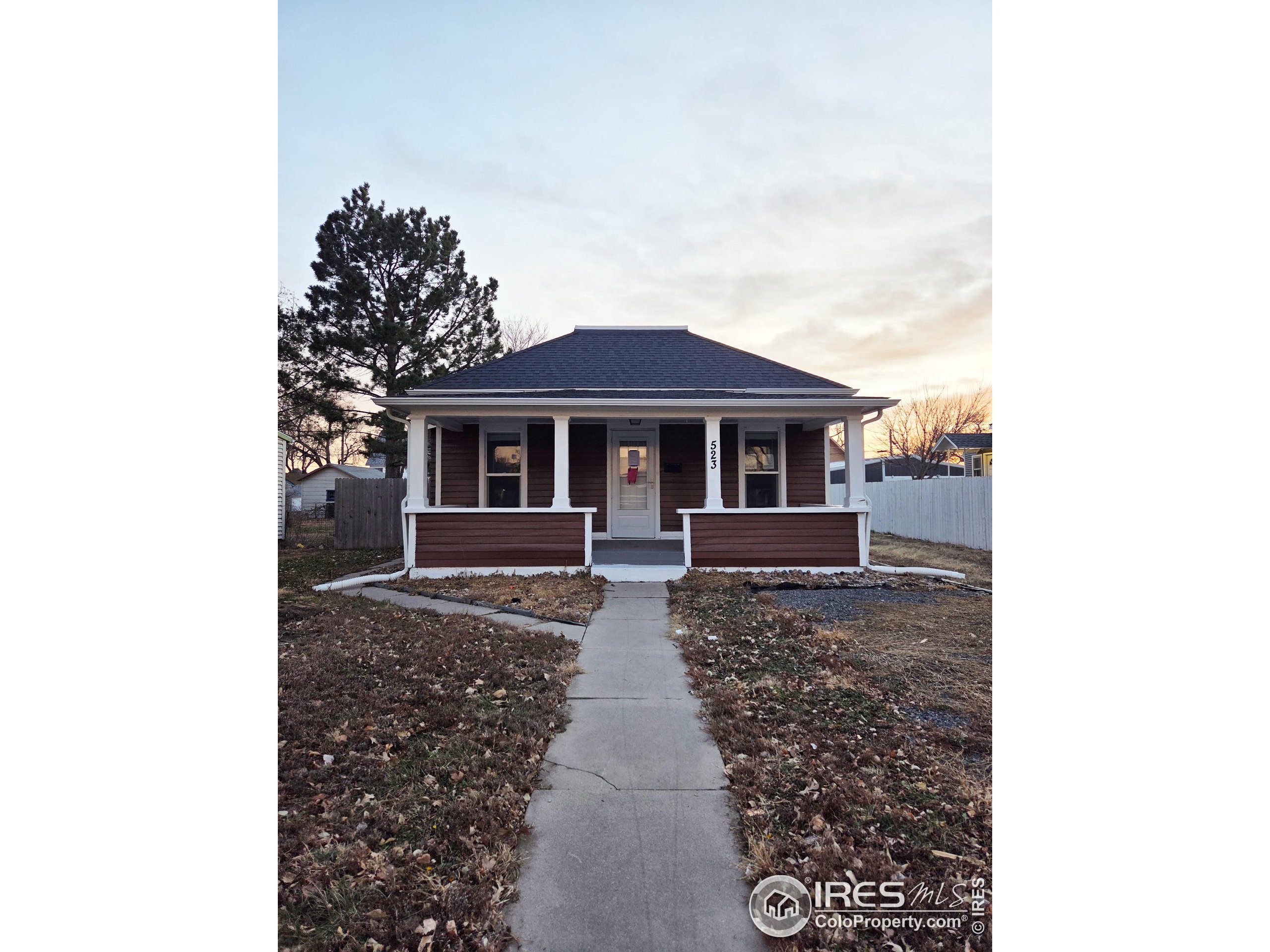 523 Chestnut Street Sterling, CO 80751 - Photo 1 of 13 a front view of a house with yard