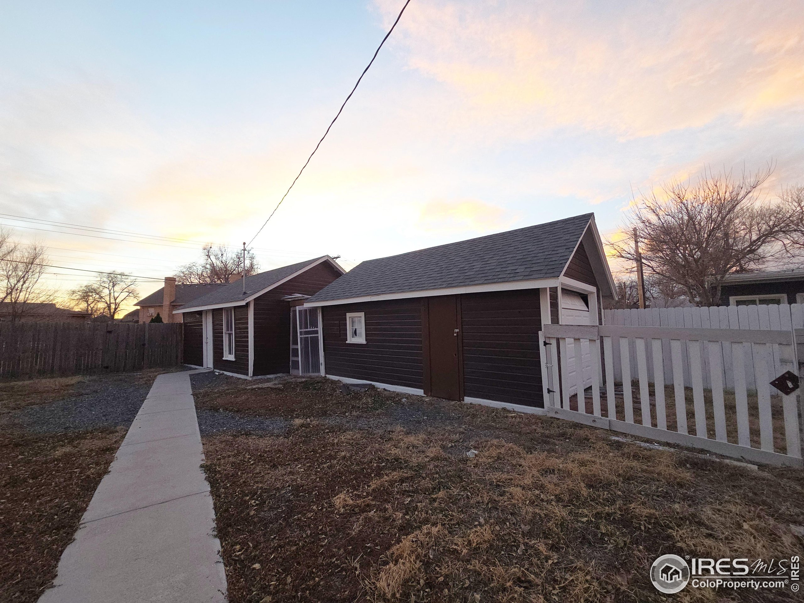 523 Chestnut Street Sterling, CO 80751 - Photo 11 of 13 a front view of house with yard and trees