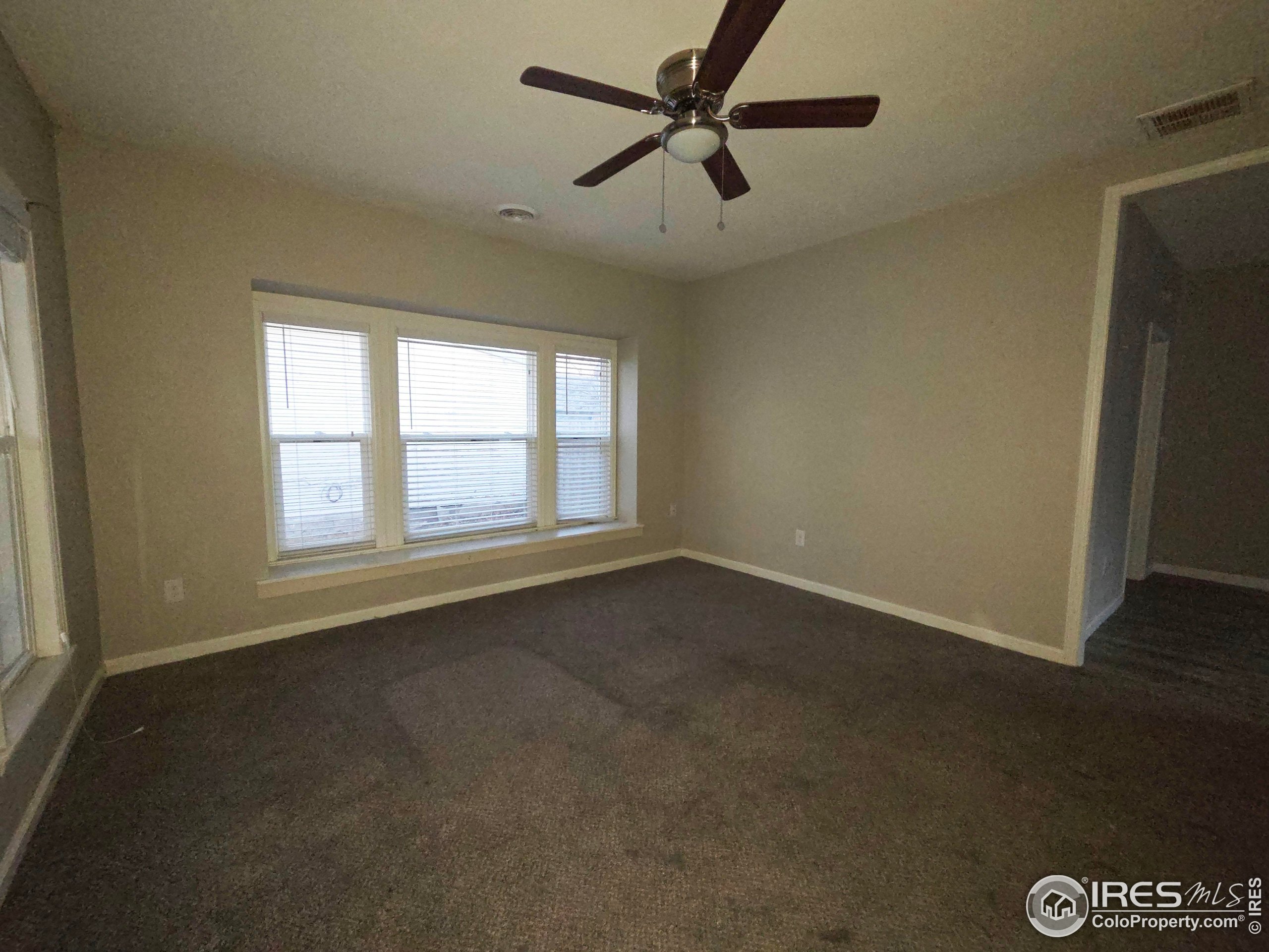 523 Chestnut Street Sterling, CO 80751 - Photo 2 of 13 an empty room with a window