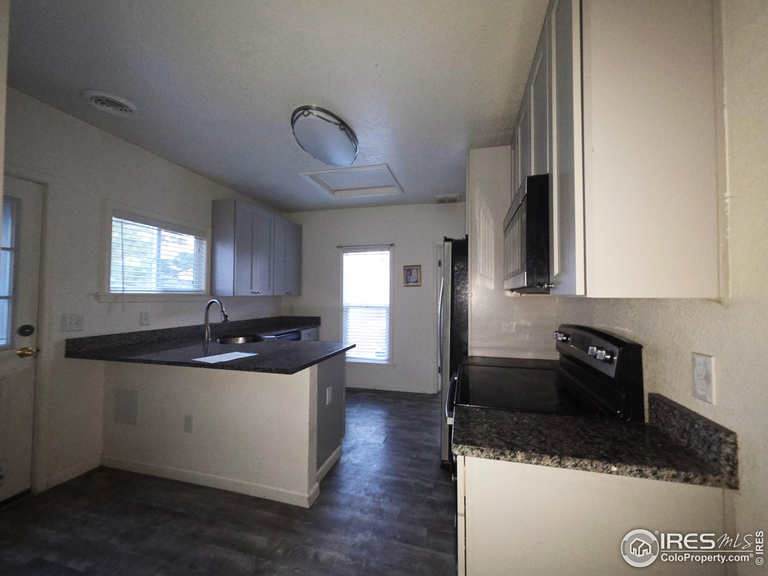 523 Chestnut Street Sterling, CO 80751 - Photo 4 of 13 a kitchen with a sink and cabinets