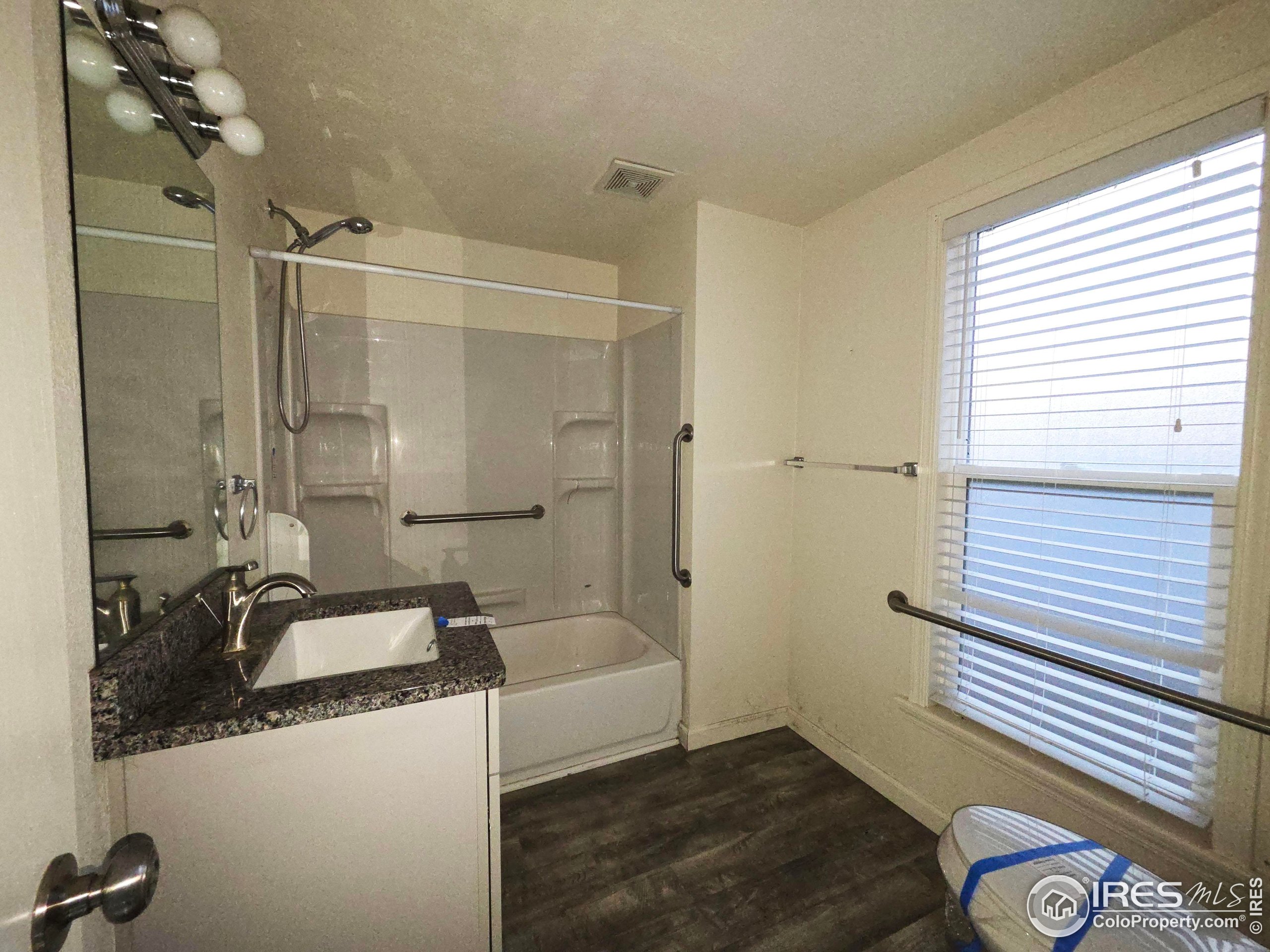 523 Chestnut Street Sterling, CO 80751 - Photo 7 of 13 a bathroom with a sink and a shower