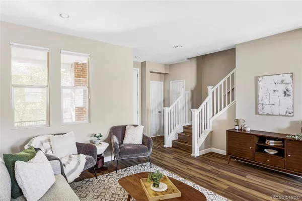 a living room with furniture and wooden floor