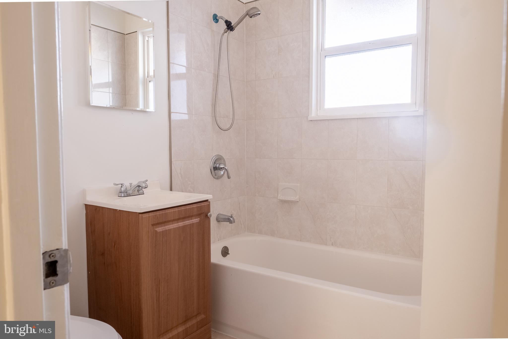2027 Barlowe Place Landover, MD 20785 - Photo 18 of 20 a bath room with a bath tub and a shower