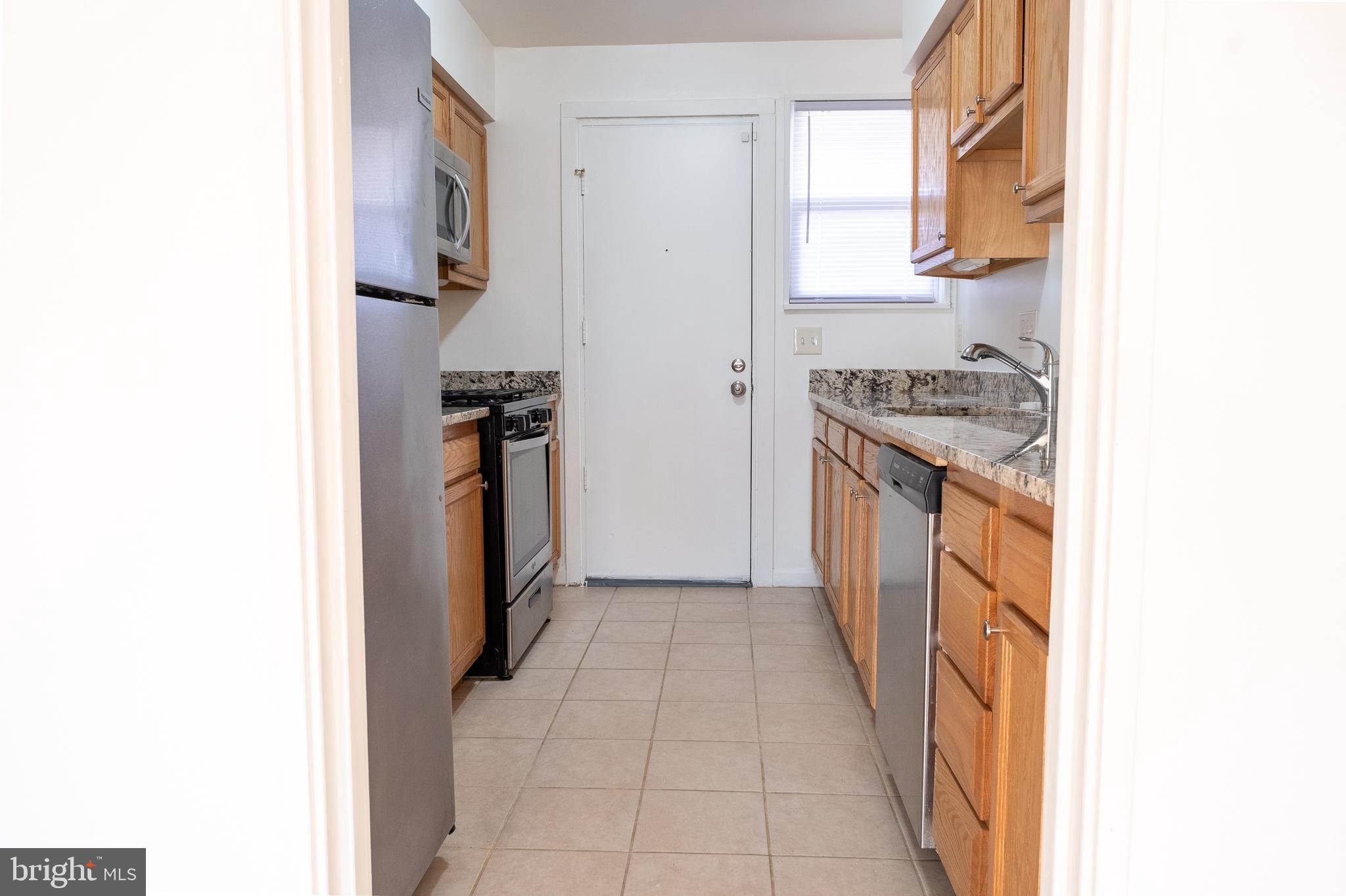 2027 Barlowe Place Landover, MD 20785 - Photo 5 of 20 a kitchen with a refrigerator and a stove
