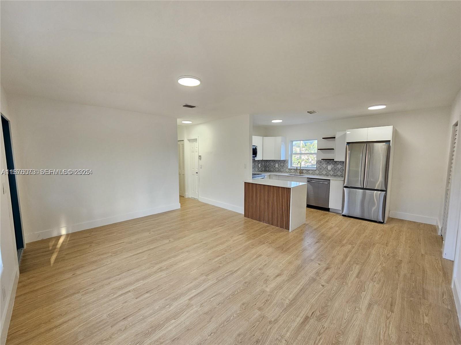 1117 West 26th Court Riviera Beach, FL 33404 - Photo 4 of 16 a view of kitchen with wooden floor