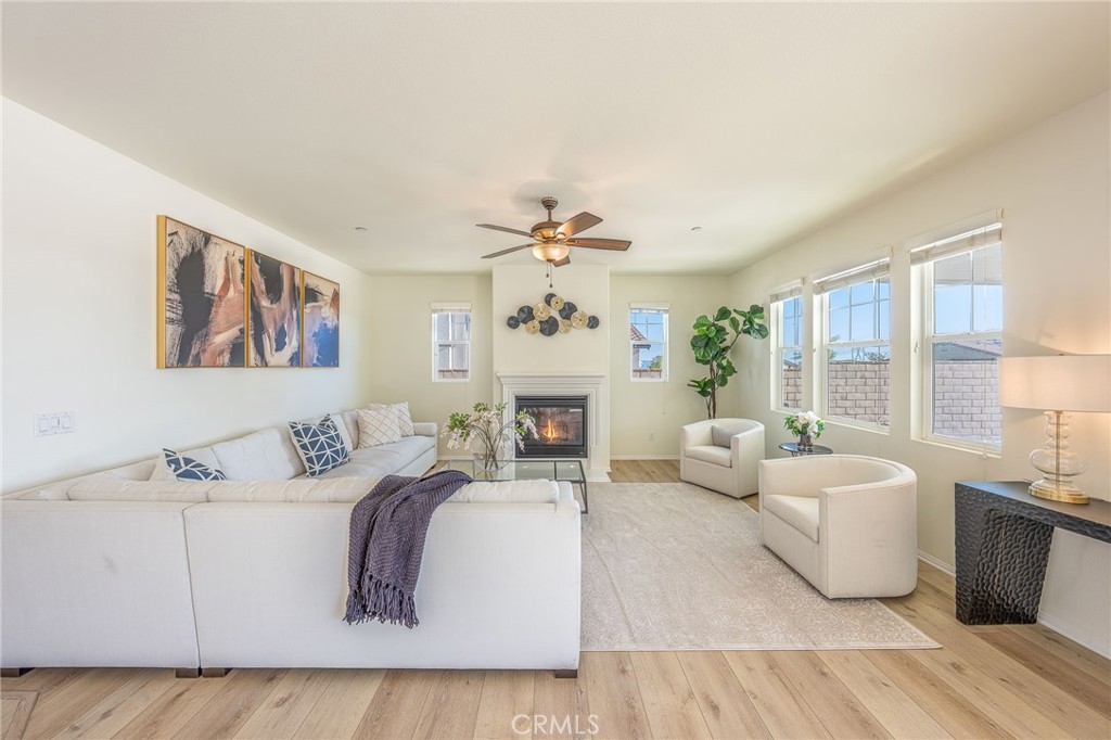 5062 Woodley Ridge Drive Rancho Cucamonga, CA 91739 - Photo 11 of 33 a living room with furniture fireplace and a large window