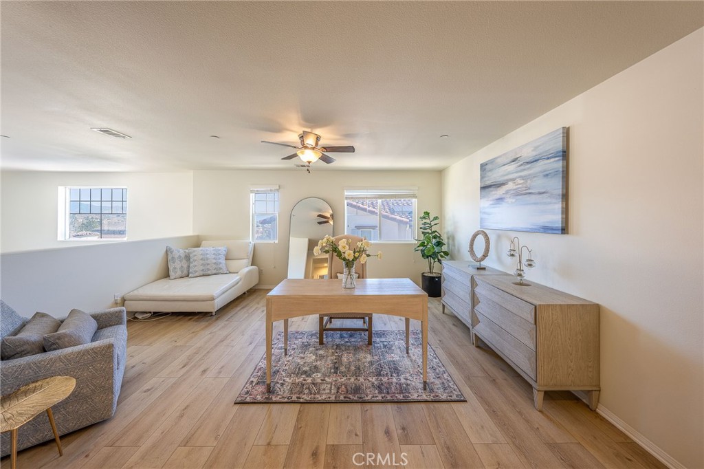 5062 Woodley Ridge Drive Rancho Cucamonga, CA 91739 - Photo 15 of 33 a living room with furniture and a chandelier