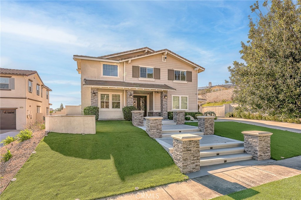 5062 Woodley Ridge Drive Rancho Cucamonga, CA 91739 - Photo 2 of 33 a front view of a house with garden and sitting area
