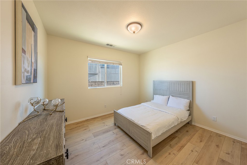5062 Woodley Ridge Drive Rancho Cucamonga, CA 91739 - Photo 21 of 33 a bedroom with a bed and window