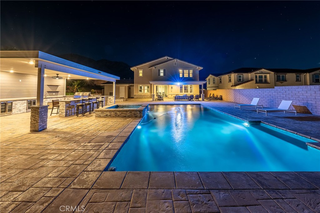 5062 Woodley Ridge Drive Rancho Cucamonga, CA 91739 - Photo 4 of 33 a view of a swimming pool with an outdoor seating