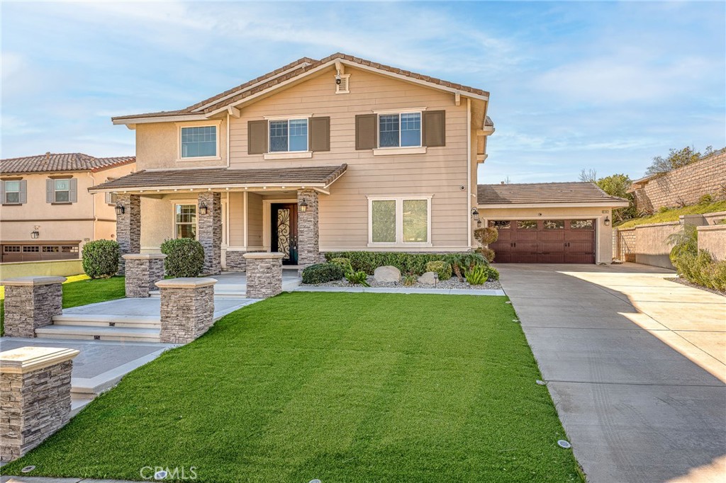 5062 Woodley Ridge Drive Rancho Cucamonga, CA 91739 - Photo 5 of 33 a front view of a house with a yard