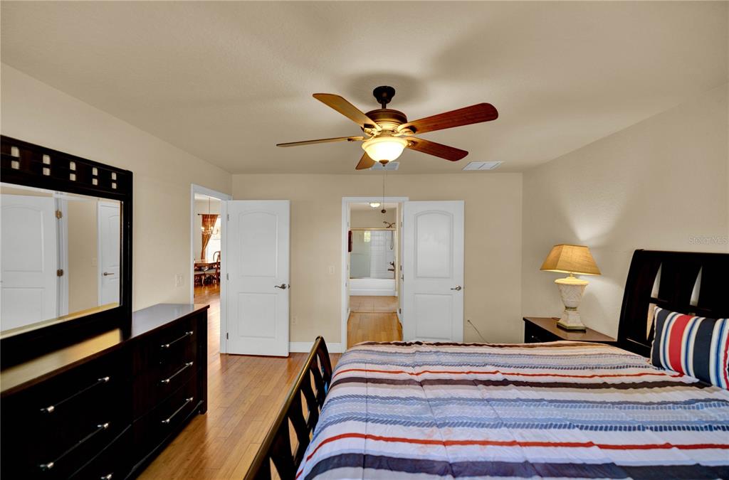 4319 Southwest 63rd Street Ocala, FL 34474 - Photo 15 of 29 a bedroom with a bed and a chandelier with a dresser
